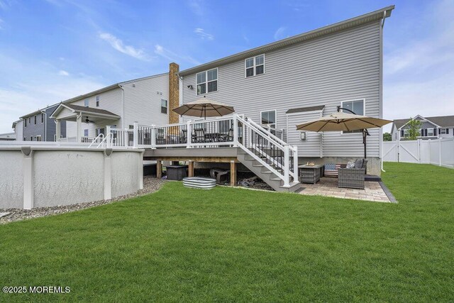 83 Weston Dr, Woolwich, NJ 08085 - back of property with a deck, a patio, and an outdoor living space with a fire pit