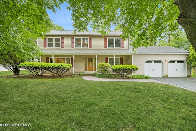 325 Oak Hill Rd, Red Bank, NJ 07701 - traditional-style house with a garage, asphalt driveway, a front lawn, and a porch