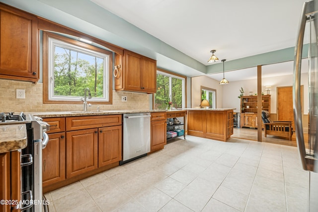 325 Oak Hill Rd, Red Bank, NJ 07701 - kitchen with appliances with stainless steel finishes, brown cabinetry, tasteful backsplash, a sink, and a peninsula