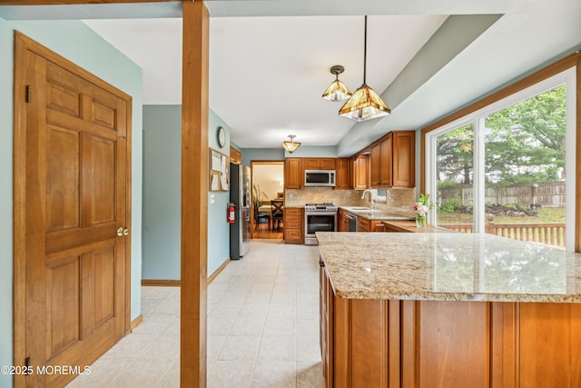 325 Oak Hill Rd, Red Bank, NJ 07701 - kitchen featuring appliances with stainless steel finishes, a sink, brown cabinetry, and plenty of natural light