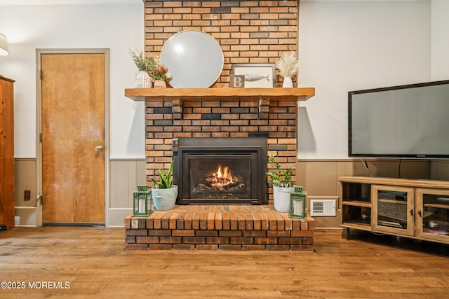 325 Oak Hill Rd, Red Bank, NJ 07701 - living area featuring a wainscoted wall, wood finished floors, and a fireplace