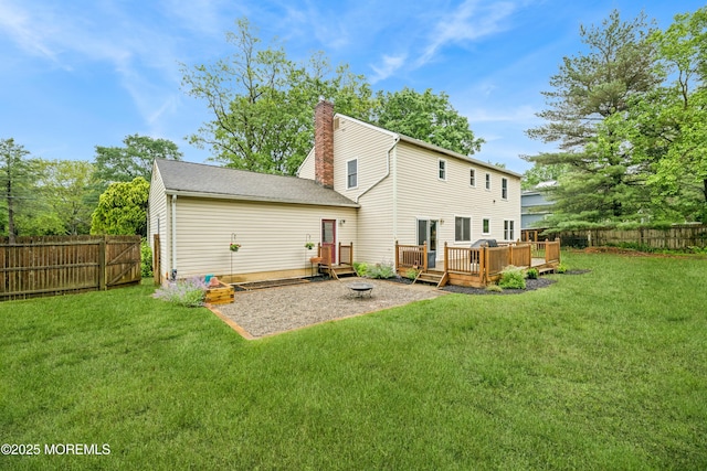 325 Oak Hill Rd, Red Bank, NJ 07701 - rear view of property with a wooden deck, a chimney, and a fire pit