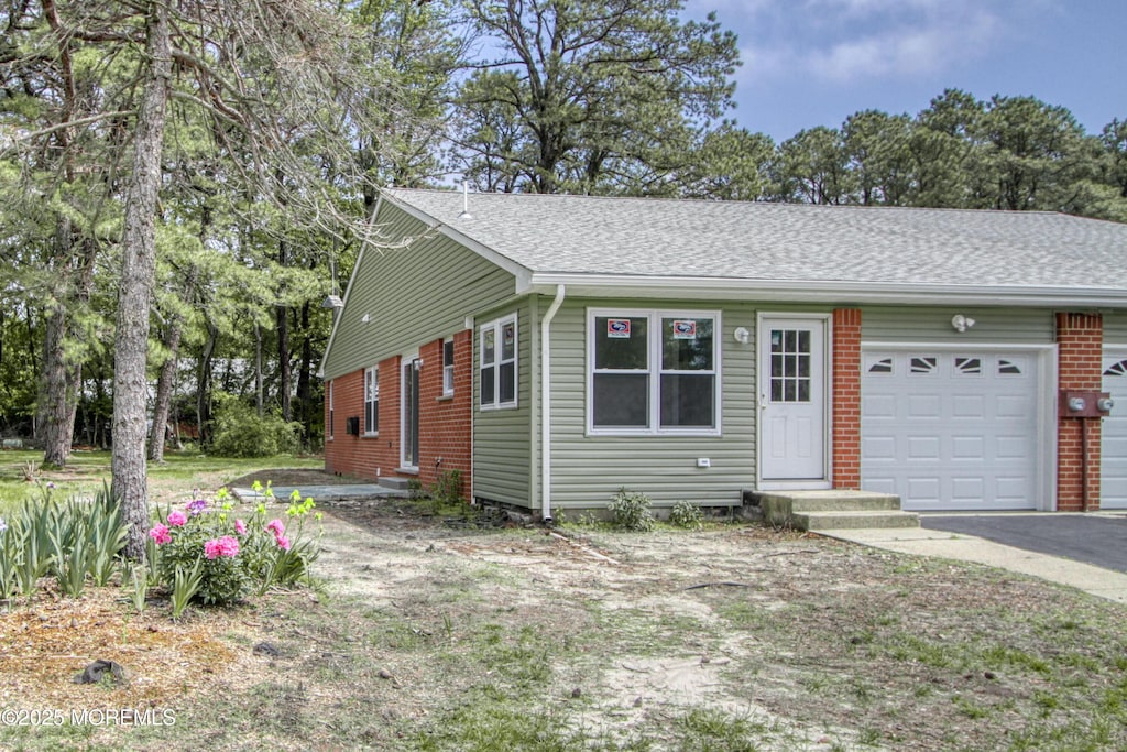 16 Moccasin Dr Unit A, Whiting, NJ 08759 - view of front facade with an attached garage, asphalt driveway, and a shingled roof