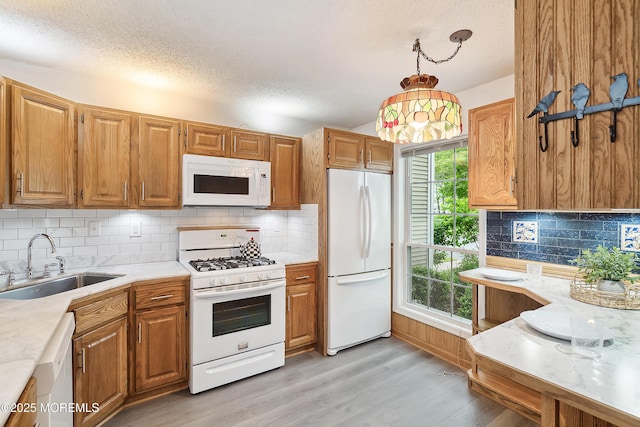 21 Steeple Chase Ct, Tinton Falls, NJ 07724 - kitchen featuring white appliances, a sink, light countertops, light wood-style floors, and backsplash