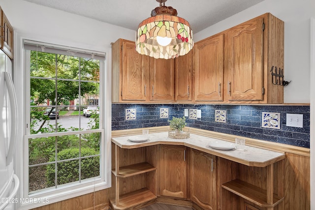 21 Steeple Chase Ct, Tinton Falls, NJ 07724 - kitchen featuring open shelves, backsplash, light countertops, and brown cabinets