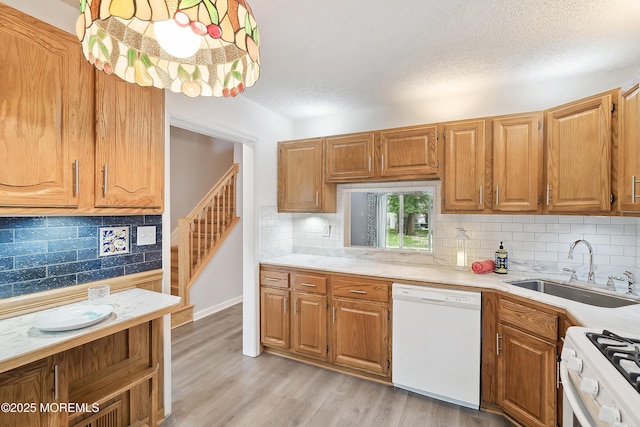 21 Steeple Chase Ct, Tinton Falls, NJ 07724 - kitchen featuring white appliances, a sink, backsplash, a textured ceiling, and light countertops