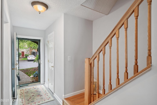 21 Steeple Chase Ct, Tinton Falls, NJ 07724 - foyer entrance featuring stairway, wood finished floors, a textured ceiling, and baseboards