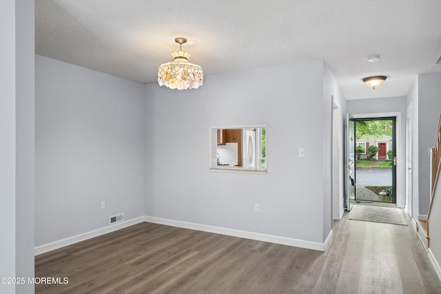 21 Steeple Chase Ct, Tinton Falls, NJ 07724 - empty room with wood finished floors, a textured ceiling, baseboards, and a smoke detector