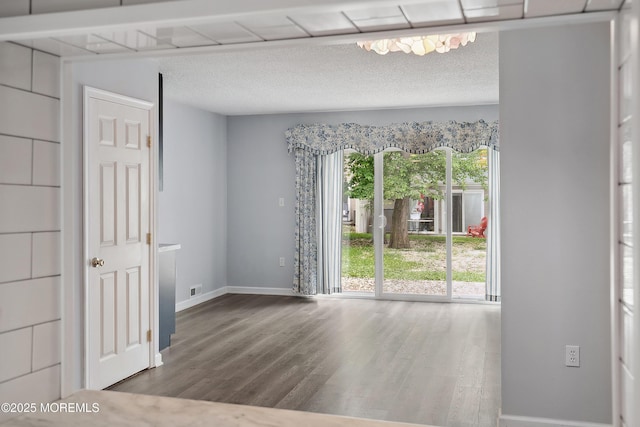 21 Steeple Chase Ct, Tinton Falls, NJ 07724 - empty room featuring wood finished floors, baseboards, and a textured ceiling