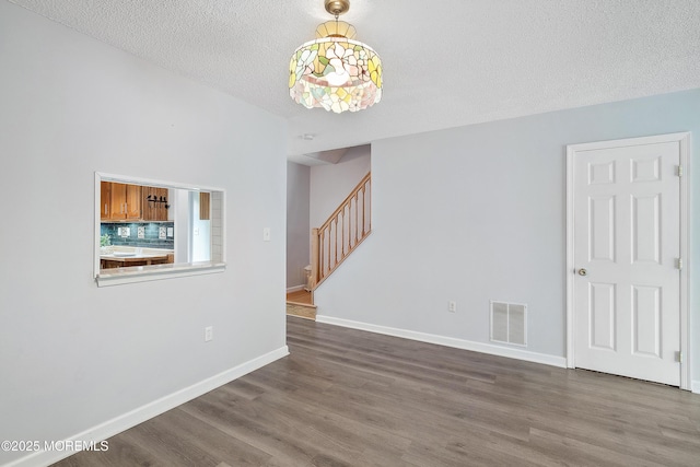 21 Steeple Chase Ct, Tinton Falls, NJ 07724 - unfurnished room with stairs, wood finished floors, baseboards, and a textured ceiling
