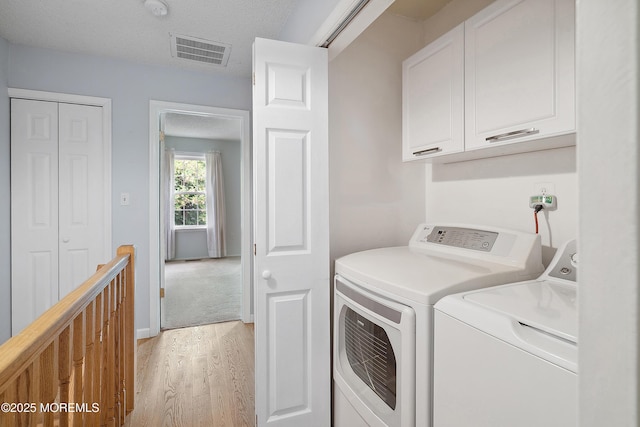 21 Steeple Chase Ct, Tinton Falls, NJ 07724 - laundry area featuring cabinet space, light wood finished floors, washer and clothes dryer, a textured ceiling, and baseboards