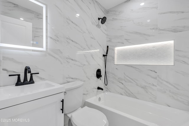 full bath with toilet, vanity, tub / shower combination, and tile walls