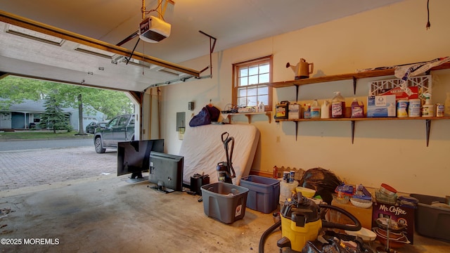 garage featuring a garage door opener and electric panel