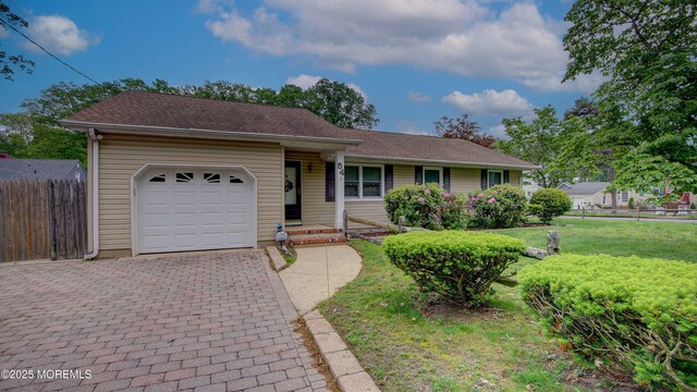 ranch-style house with an attached garage and decorative driveway