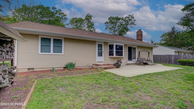 back of property with a patio, a chimney, entry steps, and crawl space