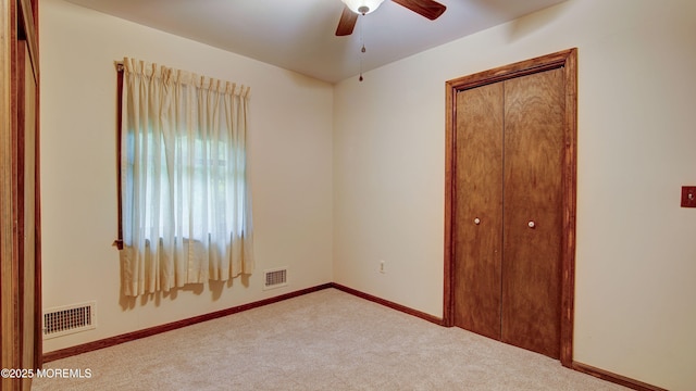 unfurnished bedroom with carpet flooring, a closet, and baseboards