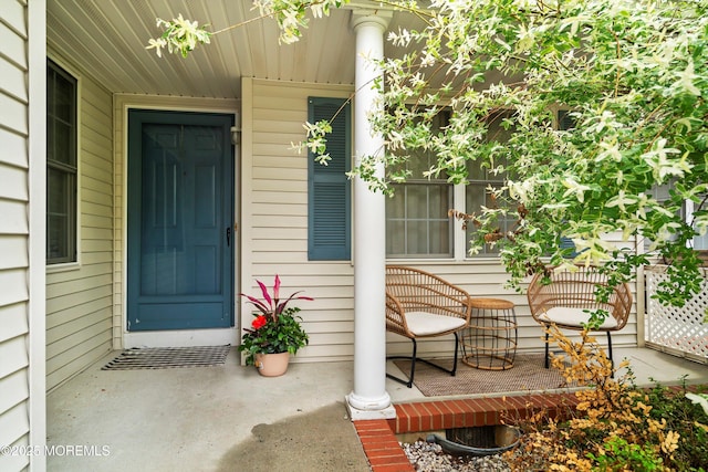 view of exterior entry with a porch