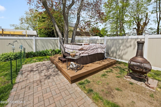 44 Cabana Dr, Brick, NJ 08723 - fenced backyard with a hot tub, an outdoor fire pit, and a wooden deck