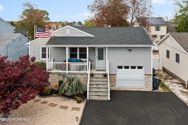 44 Cabana Dr, Brick, NJ 08723 - view of front facade with a shingled roof, a porch, driveway, stone siding, and an attached garage