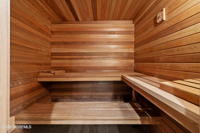 sauna with wooden ceiling and wooden walls
