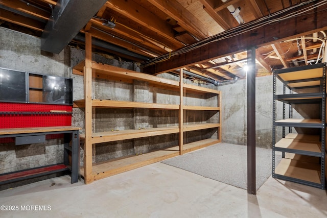 unfinished basement featuring a workshop area