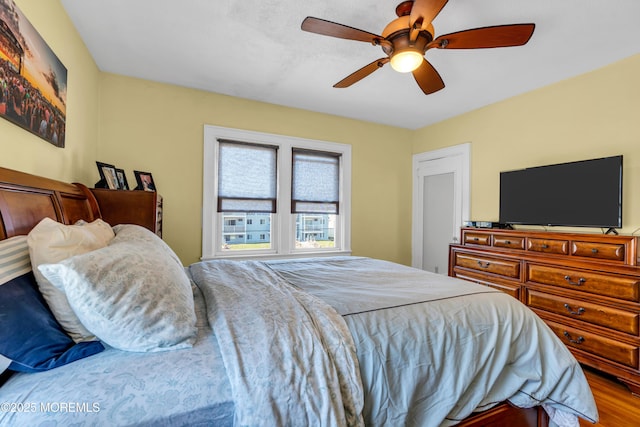 bedroom featuring wood finished floors and ceiling fan
