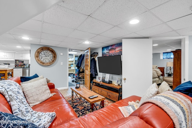 living room featuring a paneled ceiling, light tile patterned floors, recessed lighting, and baseboards