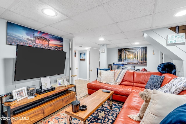 living area with a paneled ceiling, recessed lighting, and baseboards