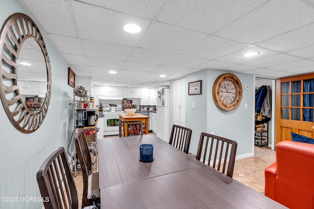 dining room featuring recessed lighting, light tile patterned floors, and a drop ceiling