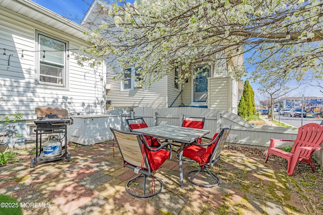 view of patio with fence, grilling area, and outdoor dining area