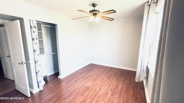unfurnished bedroom featuring baseboards, wood finished floors, and ornamental molding