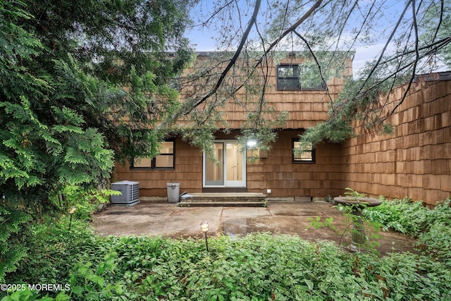 back of house featuring central air condition unit and a patio area