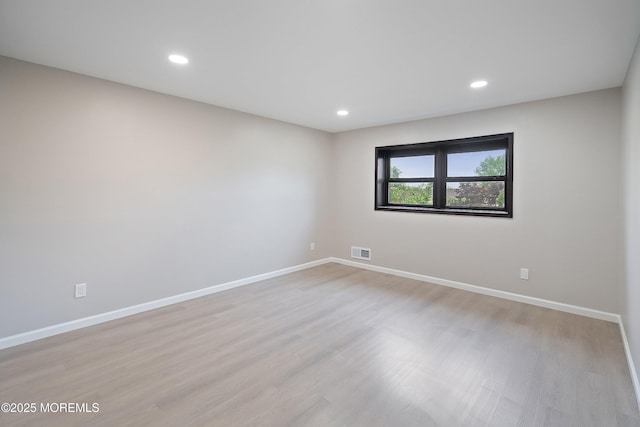 unfurnished room featuring light wood-type flooring, baseboards, and recessed lighting