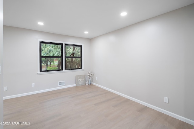 unfurnished room with light wood-style floors, baseboards, and recessed lighting