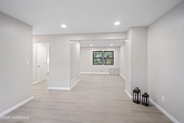 spare room with light wood-style flooring, baseboards, and recessed lighting