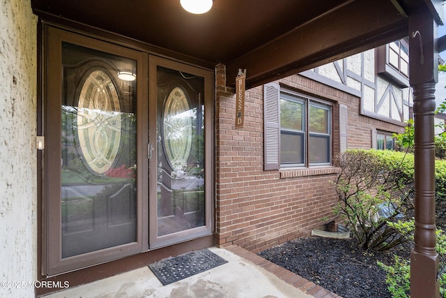 entrance to property with brick siding and french doors
