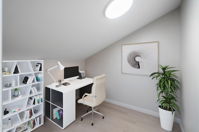home office featuring lofted ceiling, wood finished floors, and baseboards