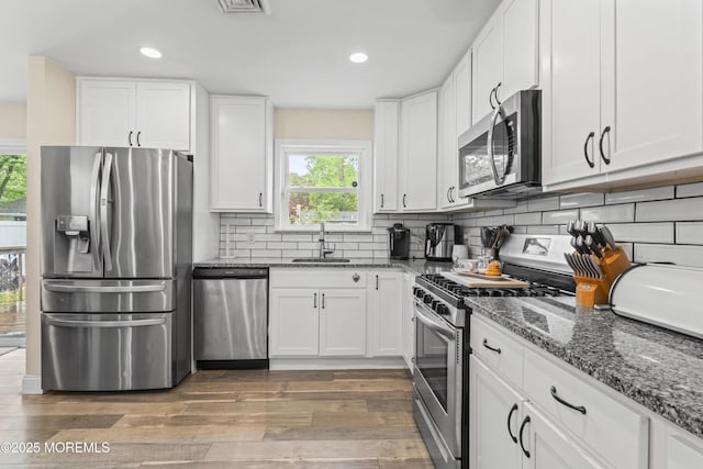 307 Seminole Trl, Browns Mills, NJ 08015 - kitchen with appliances with stainless steel finishes, a sink, light wood-style floors, white cabinetry, and recessed lighting