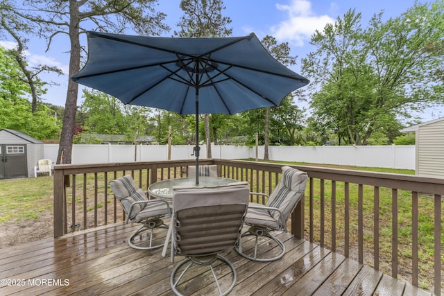 307 Seminole Trl, Browns Mills, NJ 08015 - deck featuring outdoor dining area, a storage shed, and an outbuilding