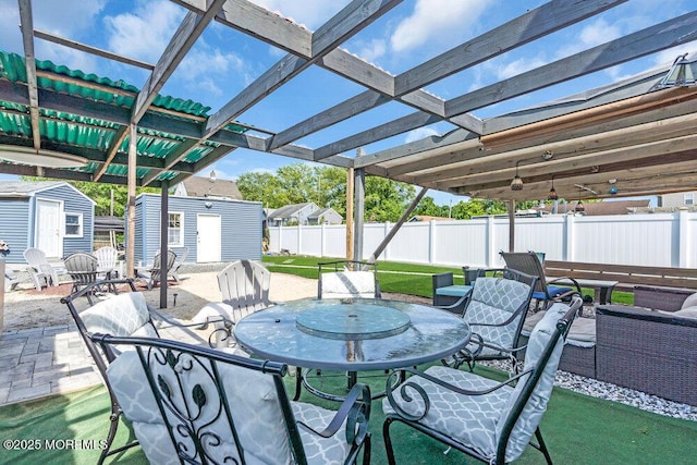 243 6th Ave, Long Branch, NJ 07740 - view of patio featuring a storage unit, an outdoor structure, fence, and outdoor dining space
