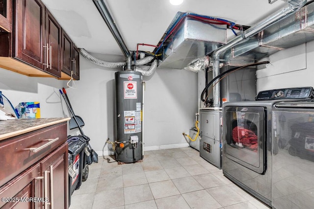 243 6th Ave, Long Branch, NJ 07740 - washroom with cabinet space, water heater, washer and clothes dryer, light tile patterned floors, and baseboards