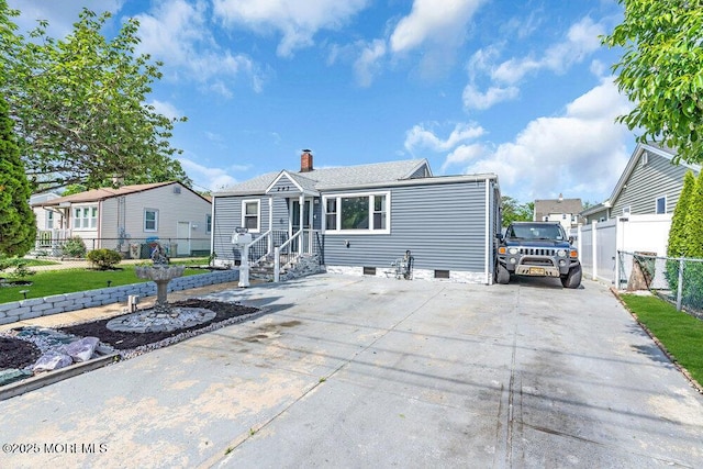 243 6th Ave, Long Branch, NJ 07740 - view of front of home with a chimney, fence, crawl space, and concrete driveway