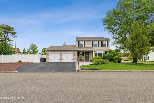 251 Worth St, Brick, NJ 08724 - view of front of house featuring a garage, asphalt driveway, and a chimney