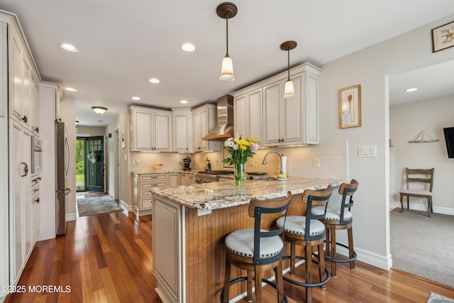 251 Worth St, Brick, NJ 08724 - kitchen with wall chimney exhaust hood, freestanding refrigerator, a peninsula, light stone countertops, and tasteful backsplash