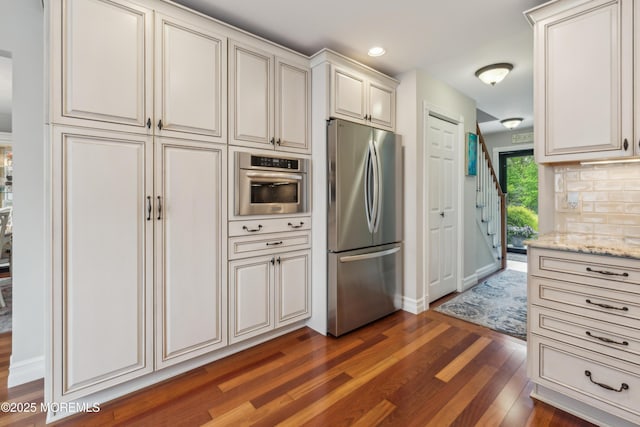 251 Worth St, Brick, NJ 08724 - kitchen with appliances with stainless steel finishes, dark wood-type flooring, recessed lighting, light stone counters, and baseboards