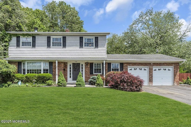 114 Newbury Rd, Howell, NJ 07731 - view of front facade with an attached garage, a front yard, asphalt driveway, and brick siding