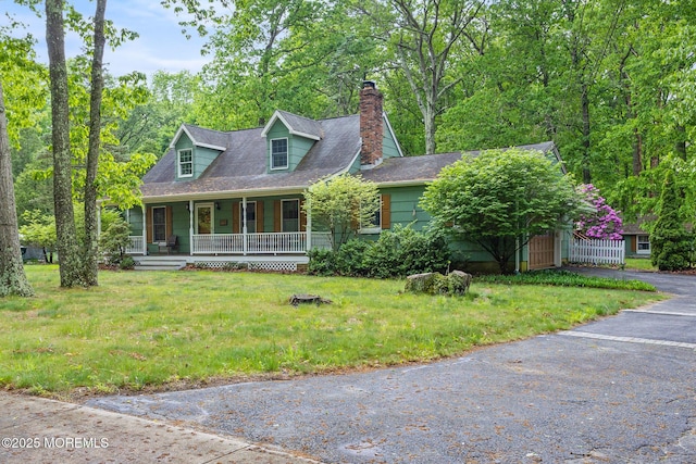 19 Kenyon Dr, Plumsted, NJ 08533 - view of front of property featuring covered porch, a chimney, and a front lawn