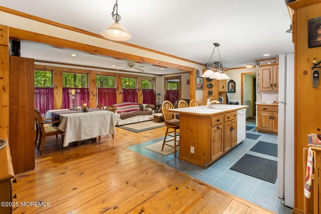 19 Kenyon Dr, Plumsted, NJ 08533 - kitchen featuring light countertops, a breakfast bar area, hardwood / wood-style flooring, an island with sink, and recessed lighting