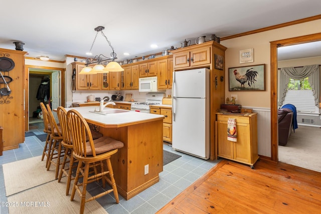 19 Kenyon Dr, Plumsted, NJ 08533 - kitchen with white appliances, a sink, light countertops, a kitchen island with sink, and a kitchen breakfast bar