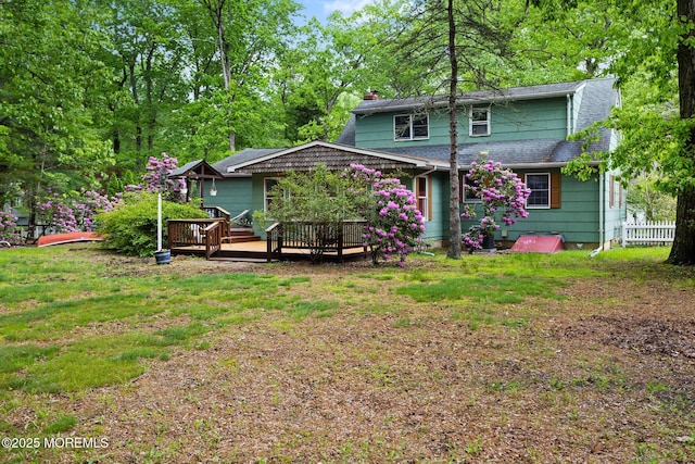 19 Kenyon Dr, Plumsted, NJ 08533 - back of property with a chimney, a wooden deck, a lawn, and a shingled roof